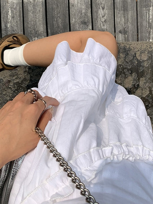 CM | Mini vestido blanco con volantes